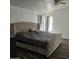 Spacious main bedroom with a king-size bed and large window at 51989 W Esch Trl, Maricopa, AZ 85139