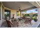 Relaxing covered patio with wicker furniture, perfect for outdoor entertaining at 5296 S Sugarberry Ct, Gilbert, AZ 85298