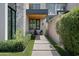Landscaped walkway leads to a home with stone and wood accents at 6933 E 1St St # B, Scottsdale, AZ 85251