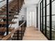 Modern hallway with hardwood floors and metal railing at 6933 E 1St St # B, Scottsdale, AZ 85251