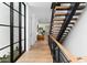 Bright hallway with hardwood floors and modern staircase at 6933 E 1St St # B, Scottsdale, AZ 85251