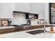 Modern kitchen with a marble backsplash and high-end appliances at 6933 E 1St St # B, Scottsdale, AZ 85251