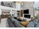 Open concept living area with a sectional sofa, fireplace, and bar area at 6933 E 1St St # B, Scottsdale, AZ 85251
