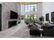 Spacious living area featuring a large sectional sofa and stone fireplace at 6933 E 1St St # B, Scottsdale, AZ 85251