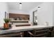 Home bar with marble countertop and wooden cabinetry at 6933 E 1St St # B, Scottsdale, AZ 85251