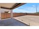 Covered patio overlooking a backyard featuring dirt landscaping and block wall fence at 7416 S 76Th Ln, Laveen, AZ 85339