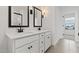 Bright bathroom with dual vanity, white cabinets, and framed mirrors with sconces at 7416 S 76Th Ln, Laveen, AZ 85339