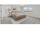 Brightly lit bedroom with neutral color palette, carpet, and view to the surrounding area at 7416 S 76Th Ln, Laveen, AZ 85339