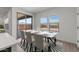 An elegant dining area with a marble table, seating for six and a view through the sliding glass doors at 7416 S 76Th Ln, Laveen, AZ 85339