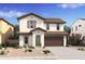 Two-story house with brown garage door and green trim at 7416 S 76Th Ln, Laveen, AZ 85339