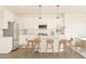 Modern kitchen with white cabinets and island at 7416 S 76Th Ln, Laveen, AZ 85339