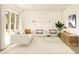 Light and airy living room with white sofa and wood accents at 7416 S 76Th Ln, Laveen, AZ 85339