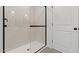 Tiled shower with glass enclosure and dark hardware and door at 7416 S 76Th Ln, Laveen, AZ 85339