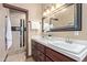 Double vanity bathroom with a large mirror and shower at 8315 E Palm Ln, Mesa, AZ 85207