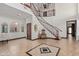 Grand entryway with a sweeping staircase, tile floors, and a chandelier at 8315 E Palm Ln, Mesa, AZ 85207