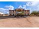 Two-story house with stucco exterior, large windows, and a porte-cochere at 8315 E Palm Ln, Mesa, AZ 85207