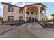 Two-story house with stucco exterior, large windows, and a porte-cochere at 8315 E Palm Ln, Mesa, AZ 85207