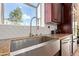 Modern kitchen featuring a farmhouse sink and stylish backsplash at 8315 E Palm Ln, Mesa, AZ 85207