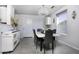Dining area with white table, gray chairs, and a crystal chandelier at 8547 W Magnum Dr, Arizona City, AZ 85123