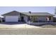 Single story home with gray exterior, landscaped yard, and attached garage at 8547 W Magnum Dr, Arizona City, AZ 85123