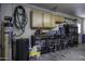 Well-equipped garage workshop featuring storage cabinets and workbenches at 8547 W Magnum Dr, Arizona City, AZ 85123