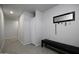 Clean and bright hallway with a folding door and bench at 8547 W Magnum Dr, Arizona City, AZ 85123