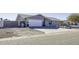 Single-story house with a white garage door and gray siding at 8547 W Magnum Dr, Arizona City, AZ 85123