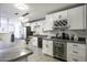 Modern kitchen with white cabinets, black countertops, and stainless steel appliances at 8547 W Magnum Dr, Arizona City, AZ 85123