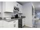 White kitchen cabinets, granite countertops, wine rack, beverage cooler at 8547 W Magnum Dr, Arizona City, AZ 85123