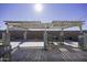 Pergola with seating area, lights, and stone pillars in backyard at 8547 W Magnum Dr, Arizona City, AZ 85123