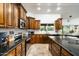 Kitchen with dark wood cabinets and granite countertops at 10484 E Mission Ln, Scottsdale, AZ 85258