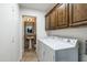 Laundry room with washer, dryer and cabinets at 10484 E Mission Ln, Scottsdale, AZ 85258