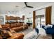 Spacious living room featuring a leather sectional sofa and access to the backyard at 10484 E Mission Ln, Scottsdale, AZ 85258