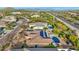 Aerial view showcasing a home with a pool, solar panels, and desert landscape at 11453 E Mark Ln, Scottsdale, AZ 85262