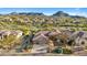 Aerial view of single-story home with pool, mountain views, and desert landscaping at 11453 E Mark Ln, Scottsdale, AZ 85262