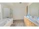 Elegant bathroom with double sinks, a soaking tub, and a walk-in shower at 11453 E Mark Ln, Scottsdale, AZ 85262