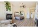 Main bedroom with a fireplace, sitting area, and large windows at 11453 E Mark Ln, Scottsdale, AZ 85262