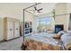 Bright bedroom with a king-size bed, built-in shelving, and large windows at 11453 E Mark Ln, Scottsdale, AZ 85262