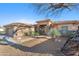 Single-story home with a two-car garage and desert landscaping at 11453 E Mark Ln, Scottsdale, AZ 85262