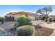 View of the side of the house, with a two-car garage and desert landscaping at 11453 E Mark Ln, Scottsdale, AZ 85262