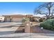 Single-story home with a two-car garage and desert landscaping at 11453 E Mark Ln, Scottsdale, AZ 85262