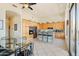 Kitchen with light wood cabinets, an island with barstools and glass dining table at 11453 E Mark Ln, Scottsdale, AZ 85262