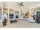 Bright and spacious living room with a fireplace, large windows, and built-in shelving at 11453 E Mark Ln, Scottsdale, AZ 85262