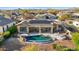 An inviting kidney shaped pool with a surrounding patio and solar panels at 11453 E Mark Ln, Scottsdale, AZ 85262