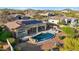 Relaxing kidney-shaped pool with rock waterfall feature and solar panels at 11453 E Mark Ln, Scottsdale, AZ 85262