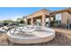 Luxury pool with patio chairs and umbrella in a desert landscape setting at 11453 E Mark Ln, Scottsdale, AZ 85262