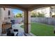 Spacious backyard with grassy lawn, fire pit, and built-in grill at 1174 E Canyon Creek Dr, Gilbert, AZ 85295