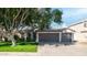 House exterior with two-car garage and large tree at 1274 N Ithica St, Gilbert, AZ 85233