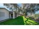 Covered patio with grassy backyard and large tree at 1274 N Ithica St, Gilbert, AZ 85233