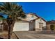 Front view of a single-story house with a two-car garage at 12810 W Edgemont Ave, Avondale, AZ 85392